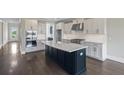 Spacious open kitchen with stainless steel appliances, large island, and sleek cabinetry at 2032 Sea Water Dr, Charleston, SC 29412