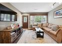 Inviting living room featuring a comfortable sofa, modern TV, stylish rug, and a bright window at 2158 Till Rd, Charleston, SC 29414