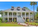 Charming two-story home with a spacious double porch,dormers, and landscaped front yard, creating a welcoming curb appeal at 2369 Rice Pond Rd, Charleston, SC 29414