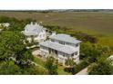 Expansive home surrounded by lush greenery and waterfront views at 2618 Raven Dr, Sullivans Island, SC 29482