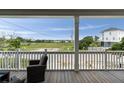 Covered porch seating area with lovely views of a waterway at 31 W 9Th St, Folly Beach, SC 29439