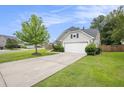 Home featuring a two-car garage and a well-manicured lawn at 341 Drayton Place Drive Dr, Moncks Corner, SC 29461