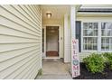 Welcoming front porch with decorative welcome sign, plants, and front door at 3486 Ashwycke St, Mount Pleasant, SC 29466