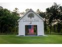 Carolina Park building with American flag, surrounded by lush greenery and mature trees at 3901 Summerton St, Mount Pleasant, SC 29466