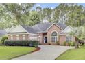 Traditional brick home with well-maintained landscaping and a circular driveway, offering great curb appeal at 4209 Wildwood Lndg, Charleston, SC 29420