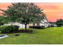 Beautiful one-story home featuring lush green lawn with landscaped bushes and trees for enhanced curb appeal at 5013 Franconia Dr, Summerville, SC 29485