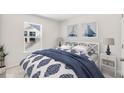 Cozy bedroom with white walls, nautical-themed artwork, and a comfortable bed dressed in blue and white bedding at 540 Verdi Dr, Summerville, SC 29486