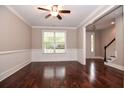Bright living room with hardwood floors, crown molding, and a large window overlooking the yard at 5540 Indigo Fields Blvd, North Charleston, SC 29418