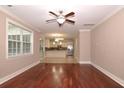 Open concept living room with hardwood floors, view of the kitchen, and plenty of natural light at 5540 Indigo Fields Blvd, North Charleston, SC 29418