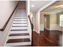 Elegant staircase with wooden banister and hardwood floors leading to the home's upper level at 5540 Indigo Fields Blvd, North Charleston, SC 29418