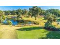 Scenic golf course with a tranquil pond, lush greenery, and mature trees creating a serene atmosphere at 5802 Palmetto Dr # B314, Isle of Palms, SC 29451