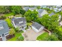An expansive aerial shot displays the property with a pool, home, garage and other neighborhood homes at 619 Thomas Glenn Ct, Charleston, SC 29412