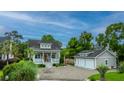 Charming home with a welcoming porch, a spacious driveway, and a detached two-car garage at 619 Thomas Glenn Ct, Charleston, SC 29412