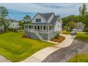 Charming home with a lush yard, features a covered porch and ample parking at 637 Lynne Ave, Charleston, SC 29412