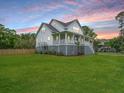 Two story home featuring a spacious lawn and elevated porch at 637 Lynne Ave, Charleston, SC 29412