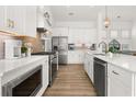 Modern kitchen boasting stainless steel appliances, white cabinetry, tile backsplash, and an open layout at 703 Blueway Ave, Summerville, SC 29486
