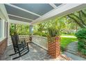Inviting front porch with rocking chairs and classic brick accents at 802 Robert E. Lee Blvd, Charleston, SC 29412