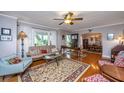 Cozy living room with hardwood floors, ceiling fan, and natural light at 802 Robert E. Lee Blvd, Charleston, SC 29412