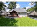 Spacious backyard featuring a wooden deck, fenced yard, and well-maintained lawn at 8320 Tyrian Path, North Charleston, SC 29418