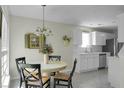 Bright eat-in kitchen boasts white cabinets and stainless steel appliances creating a clean and modern space at 9255 Ayscough Rd, Summerville, SC 29485