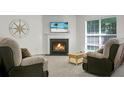 Cozy living room features a fireplace, neutral paint, and new carpet; ideal for relaxing and entertaining at 9255 Ayscough Rd, Summerville, SC 29485