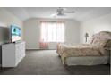 Spacious bedroom with a large window, neutral walls, and a ceiling fan for added comfort at 9255 Ayscough Rd, Summerville, SC 29485