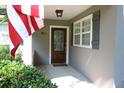 Inviting front porch showcasing a decorative door and American flag, creating a warm welcome at 963 Yorktown Dr, Charleston, SC 29412