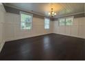 Spacious living room with dark hardwood floors, paneled walls, and plenty of natural light at 963 Yorktown Dr, Charleston, SC 29412