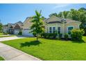 Inviting home exterior with lush green lawn, mature landscaping, and a well-maintained facade at 9710 Table Mountain Ln, Ladson, SC 29456