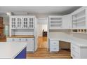 Bright kitchen featuring white cabinetry, a contrasting blue island, and wood floors at 100 Dacs Ln, Summerville, SC 29483