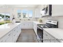 Well-lit kitchen with a view, featuring white cabinetry, quartz countertops, and modern appliances at 1009 Marsh Harrier Dr # Cc3-2-2P, Ravenel, SC 29470
