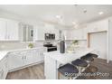Bright kitchen with white cabinetry, stainless steel appliances, and a spacious center island at 1009 Marsh Harrier Dr # Cc3-2-2P, Ravenel, SC 29470