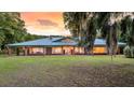 Spacious brick home with a green metal roof, large windows and a well-maintained lawn at 1085 Harts Bluff Rd, Wadmalaw Island, SC 29487