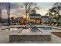 Expansive backyard boasts a luxurious pool, spa, and covered patio perfect for entertaining and leisure at 1098 Reserve Ln, Awendaw, SC 29429