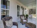 Inviting porch with rocking chairs and decorative pillows creates a cozy outdoor seating area at 1098 Reserve Ln, Awendaw, SC 29429