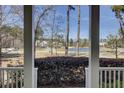 Scenic view from the porch overlooking a serene lake and lush green landscape at 1098 Reserve Ln, Awendaw, SC 29429