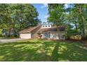 Inviting front exterior showcasing a well-maintained lawn and mature landscaping at 1129 Shady Grove Ln, Mount Pleasant, SC 29464