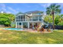 A backyard paradise featuring a pool, bar, fire pit, and outdoor seating, perfect for relaxation at 1143 Sea Eagle Watch, Charleston, SC 29412