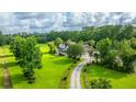 Aerial view of a gorgeous home with an expansive front yard and a long driveway at 120 Greenhill Pastures, Summerville, SC 29483