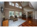 A spacious living room with hardwood floors, neutral walls, and large windows for natural light at 120 Greenhill Pastures, Summerville, SC 29483