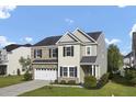 Charming home featuring a brick and siding exterior, an attached garage, and a nicely landscaped front yard at 123 Blackwater Way, Moncks Corner, SC 29461