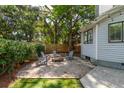 Inviting backyard area with gravel, string lights, and Adirondack chairs surrounding a fire pit at 1274 Hampshire Rd, Charleston, SC 29412