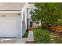Attractive home exterior with well-maintained landscaping, a one car garage, and a welcoming front porch at 1274 Hampshire Rd, Charleston, SC 29412