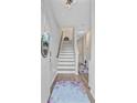 Bright foyer with staircase, hardwood flooring, and welcoming decor at 136 Rowans Creek Dr, Charleston, SC 29492