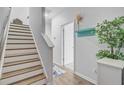 Hallway featuring a staircase with wooden steps and a decorative shelf with hooks at 136 Rowans Creek Dr, Charleston, SC 29492