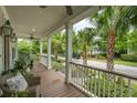 Inviting front porch featuring comfortable seating and a view of the palm tree-lined street at 1407 Wando View St, Daniel Island, SC 29492