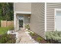 Charming front entrance with a decorative door, landscaping, and manicured garden with white rocks at 141 Lagoona Dr, Summerville, SC 29483