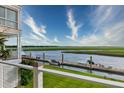 Scenic waterfront view with a private dock, boats, and lush green surroundings on a sunny day at 1646 Marsh Harbor Ln, Mount Pleasant, SC 29464