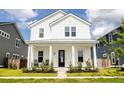 Beautiful two-story white home with a welcoming front porch and well-maintained landscaping at 165 Country Gate Ln, Summerville, SC 29485