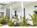 Inviting front porch with rocking chairs, lush landscaping, and a charming entrance at 165 Country Gate Ln, Summerville, SC 29485